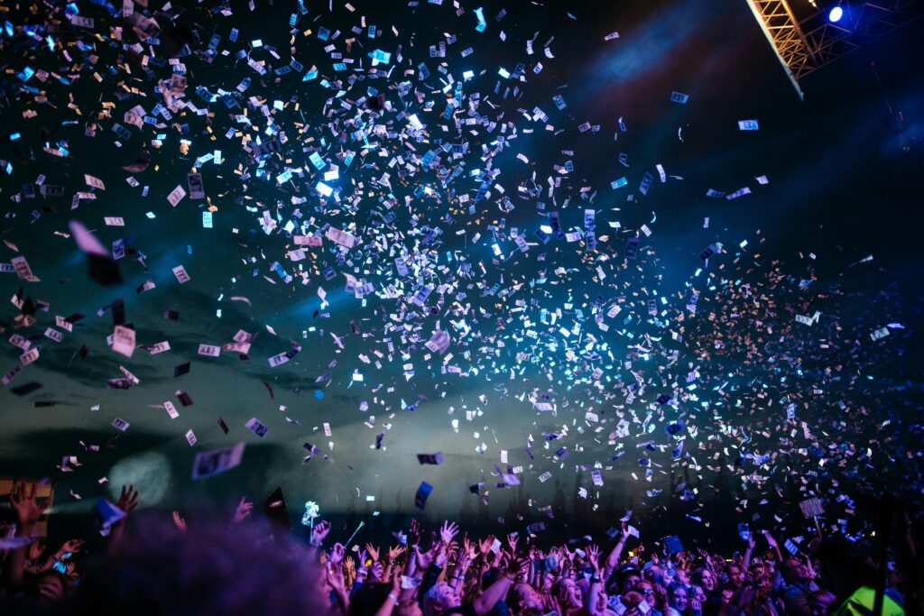 Music festival with confetti falling through the air on top of the crowd