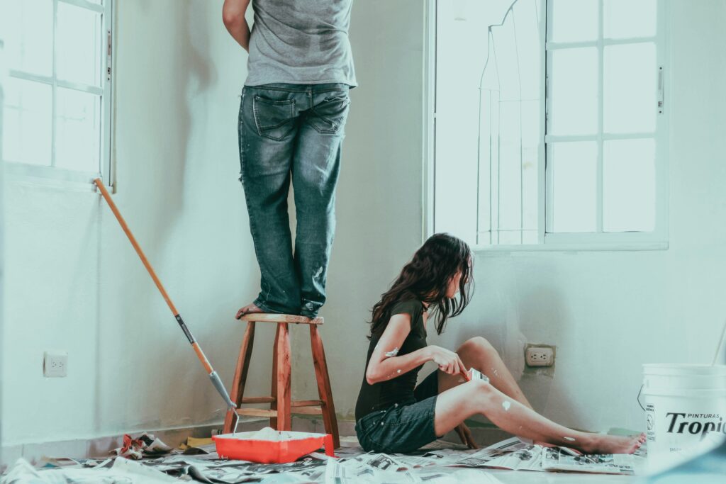 Man and woman painting a room