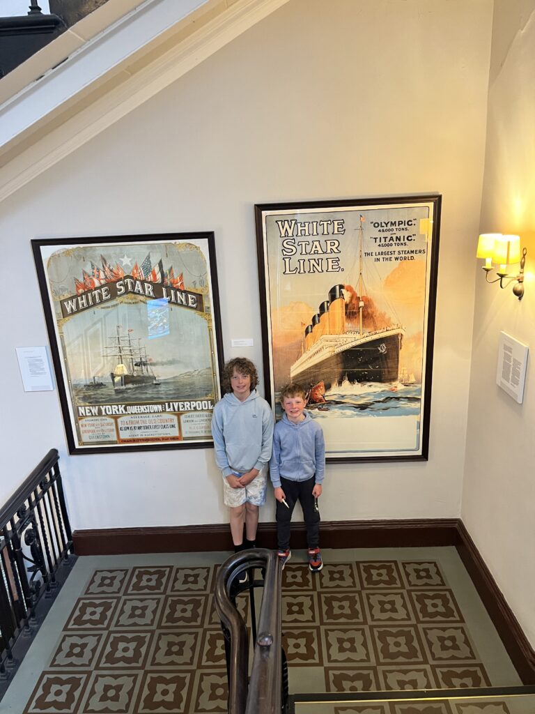 Two boys standing in front of posts of the Titanic