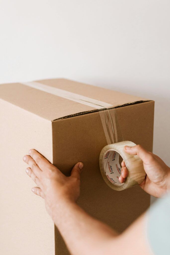 Someone putting cellotape on a box
