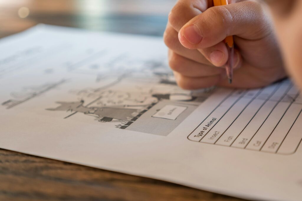 Child writing on an exam paper