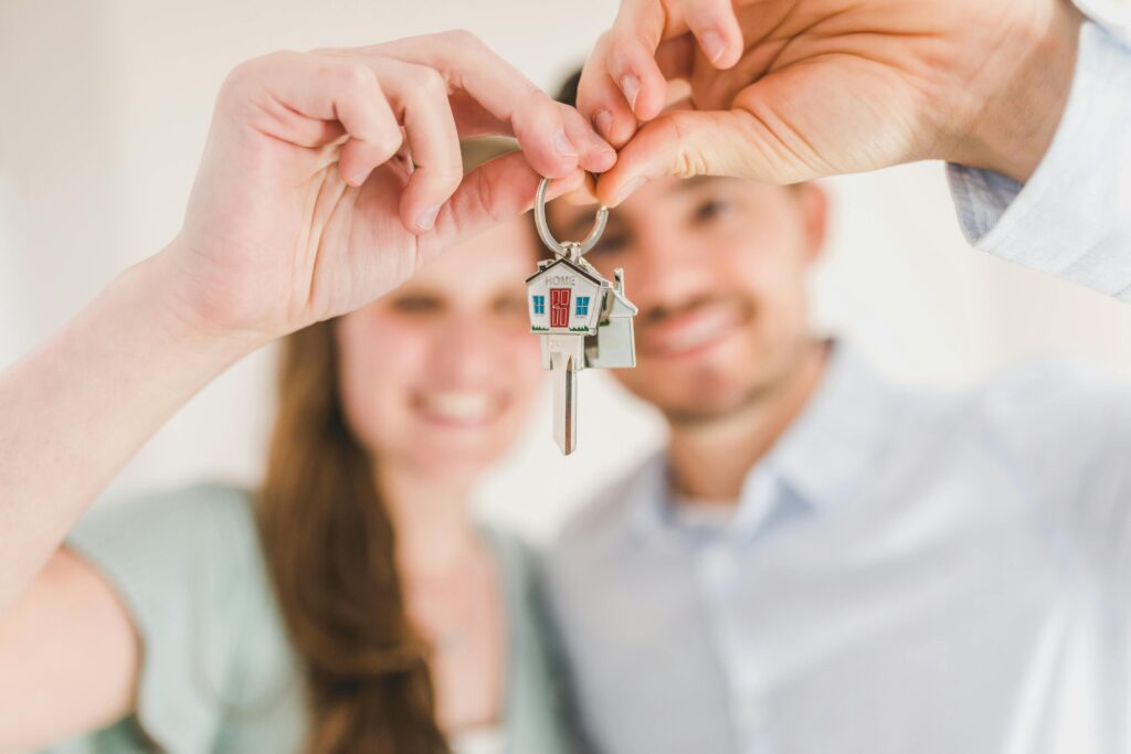 Couple holding up keys to their first home