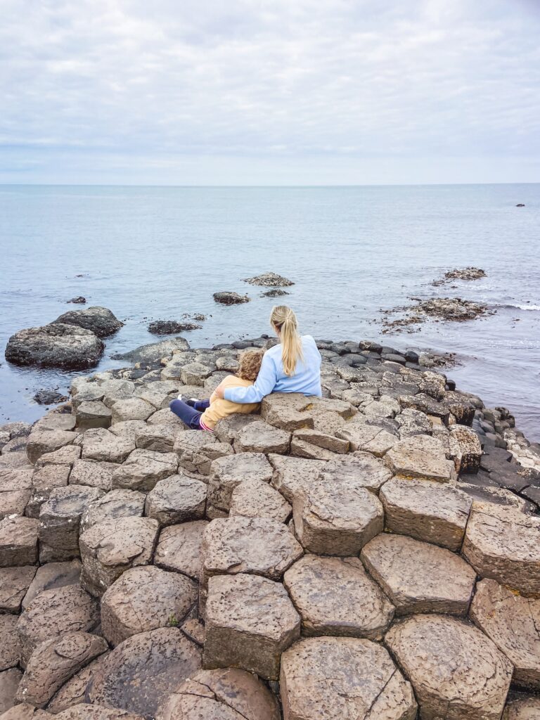 Woman and child sitting on the Giant's Causeway