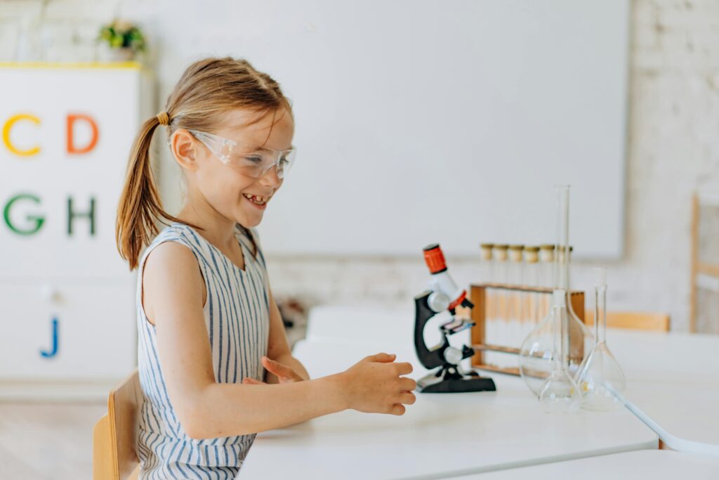 Girl smiling at science equipment
