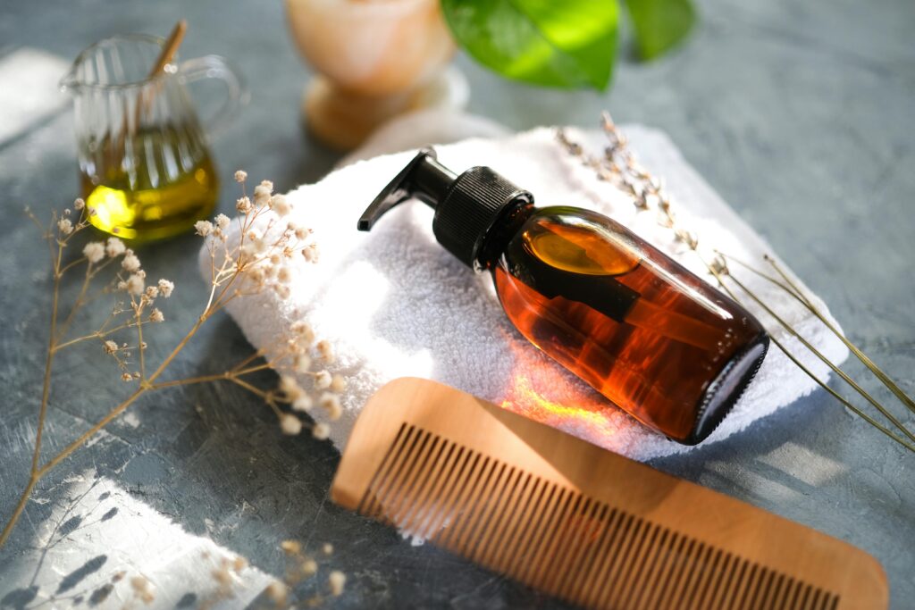 Comb and bottle of cosmetic oil