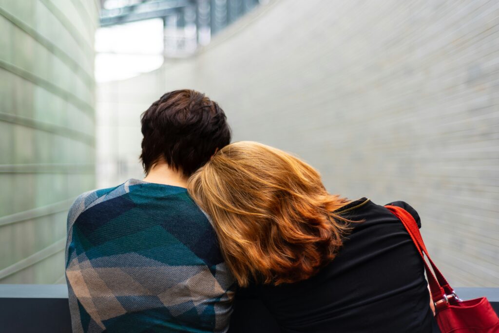 Person resting their head on another persons shoulder