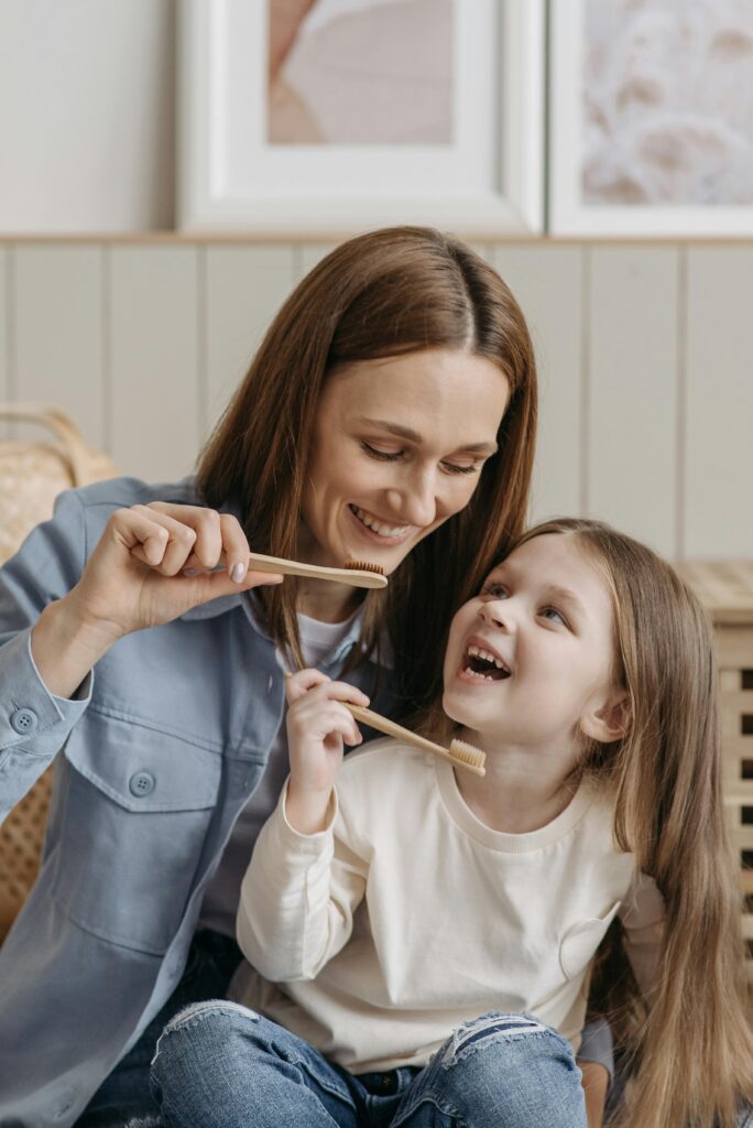 Child and mother brushing their teeth