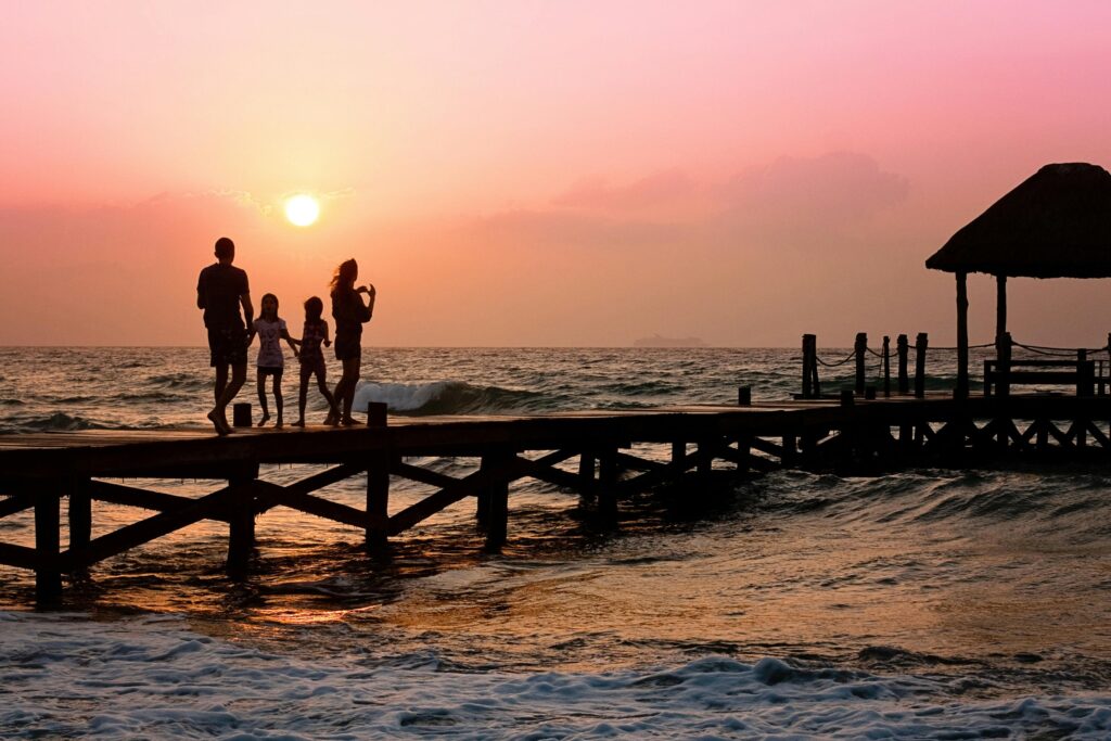 People standing on a dock during sunset