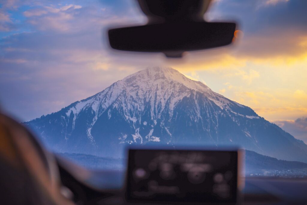 View of a snow-capped mountain from inside a car
