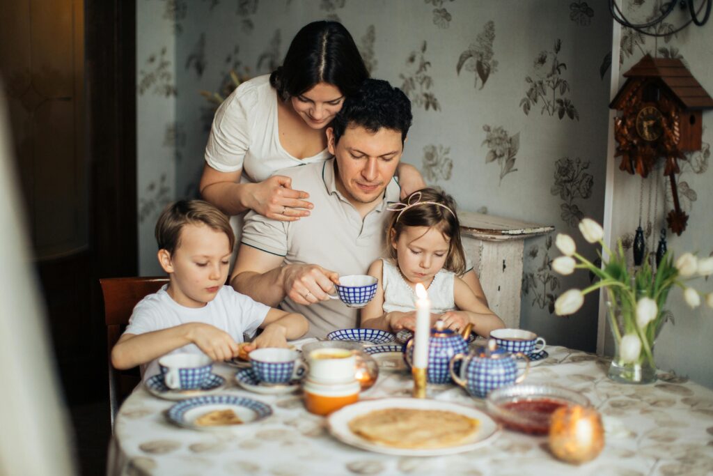 Family sitting at a table enjoy tea