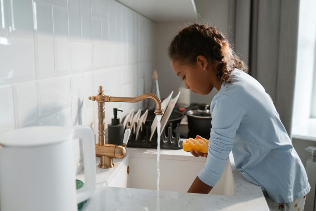 Diligent Girl Cleaning the Dishes
