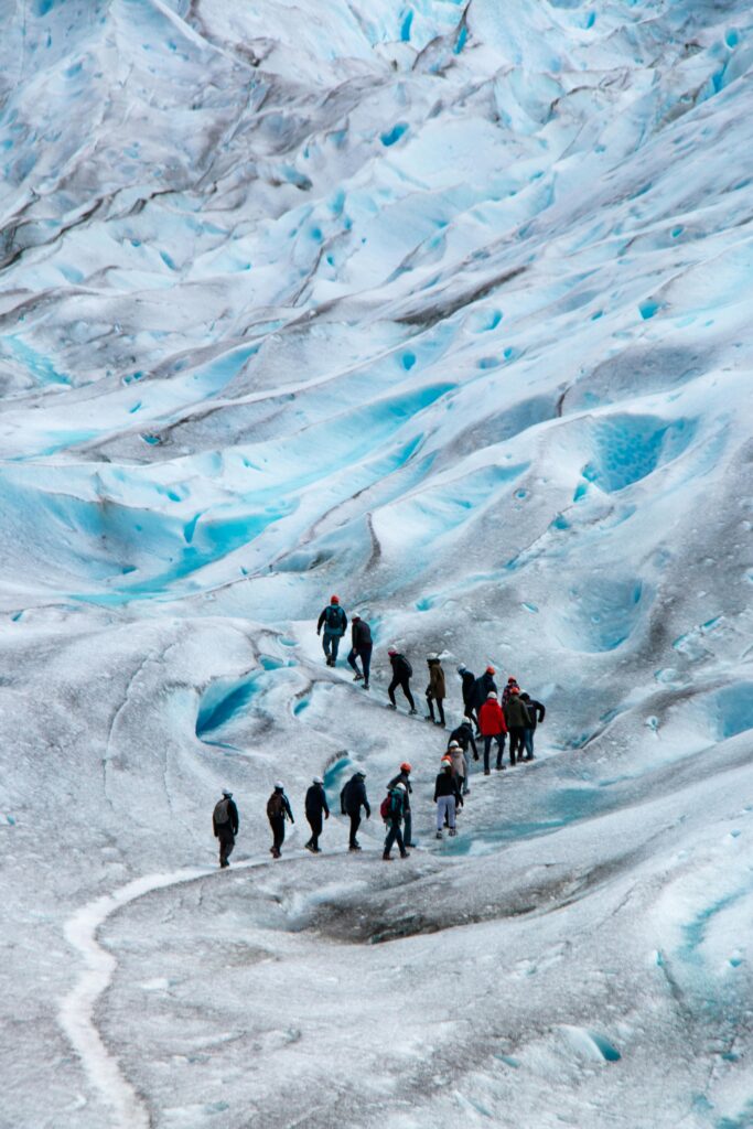 Hikers climbing on a glacier