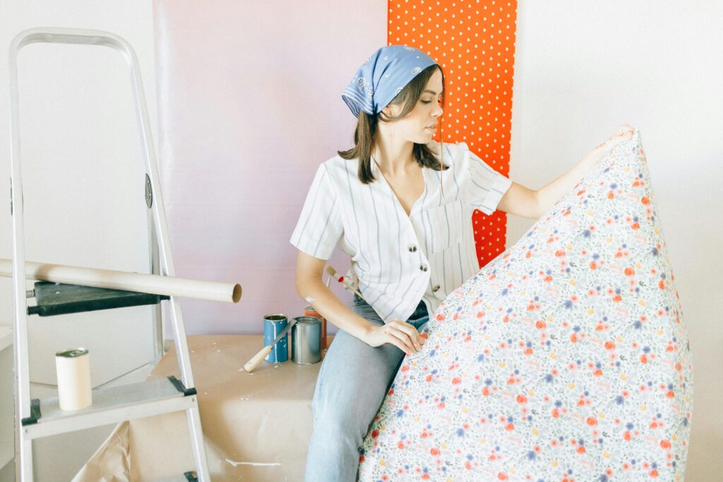 Woman wearing a blue bandana looking at wallpaper