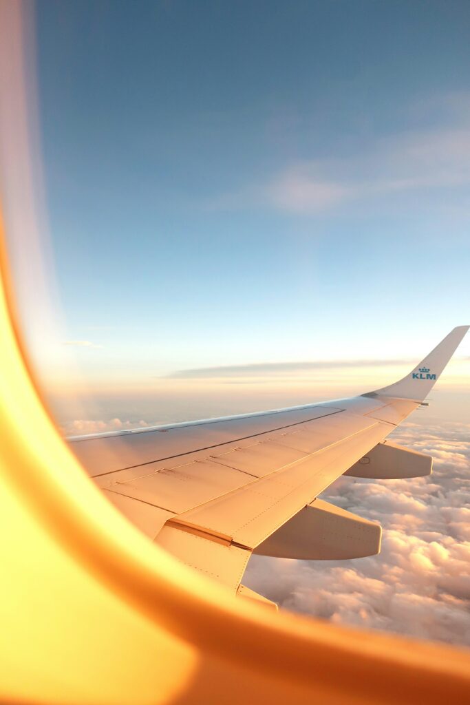 Outside view of a plane flying over clouds