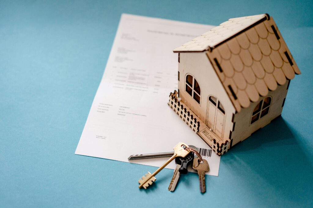 Wooden toy house with paper and keys
