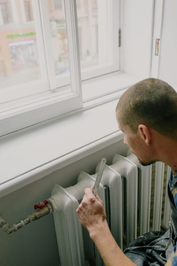 Handyman fixing a radiator