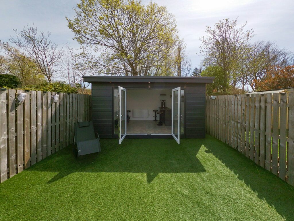 Garden room in a back garden with fences