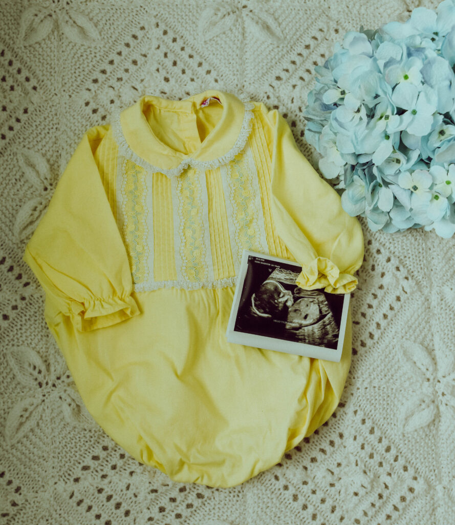 Lemon coloured baby romper with baby scan photo