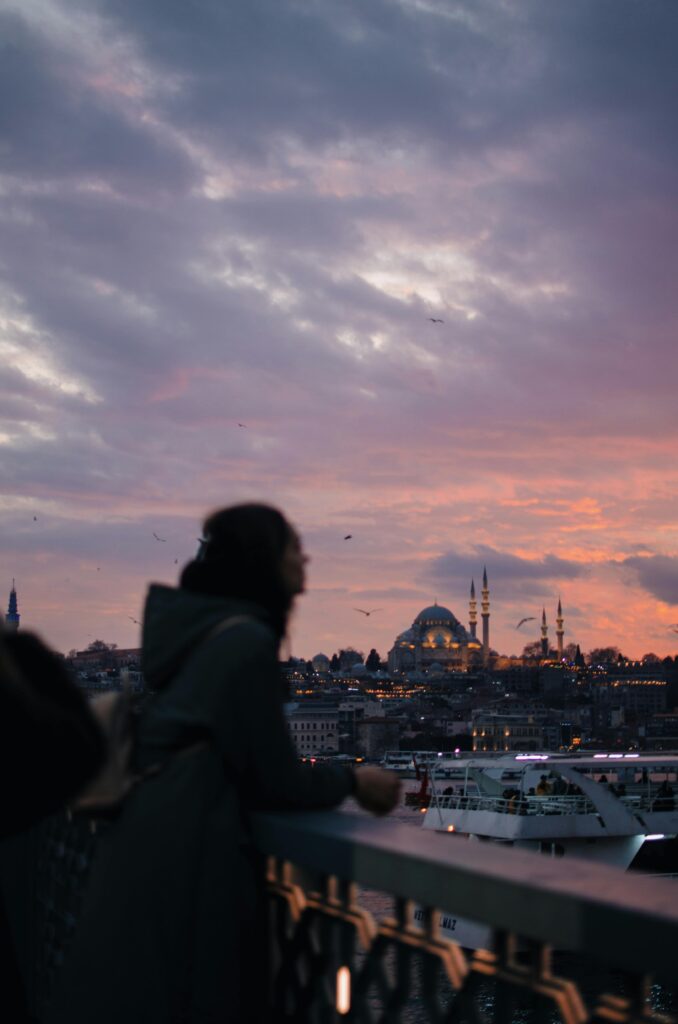 Anonymous woman looking at Istanbul over the water