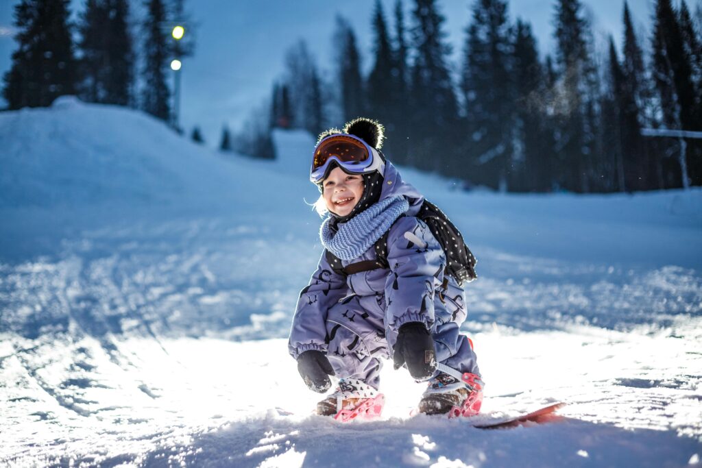 Smiling child on a snowboard