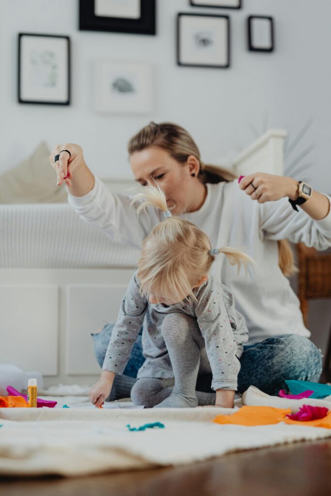 Mother and child doing arts and crafts on the floor