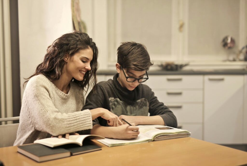 Mother and son studying at a kitchen table