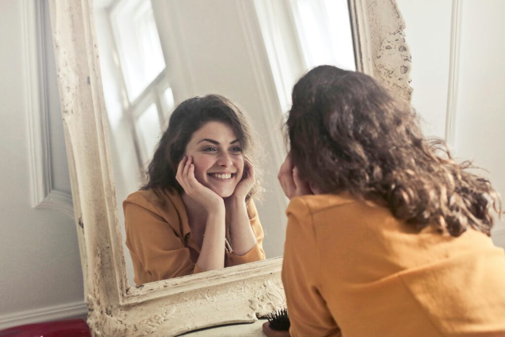 Woman looking in the mirror smiling