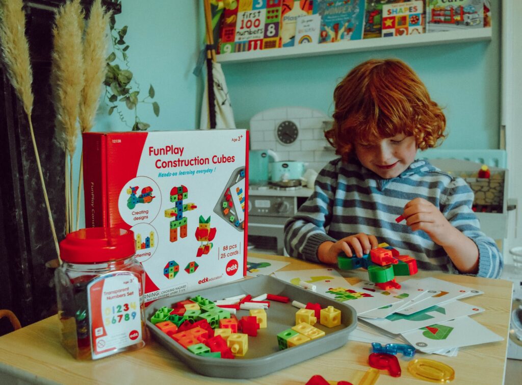 Child playing with construction cubes