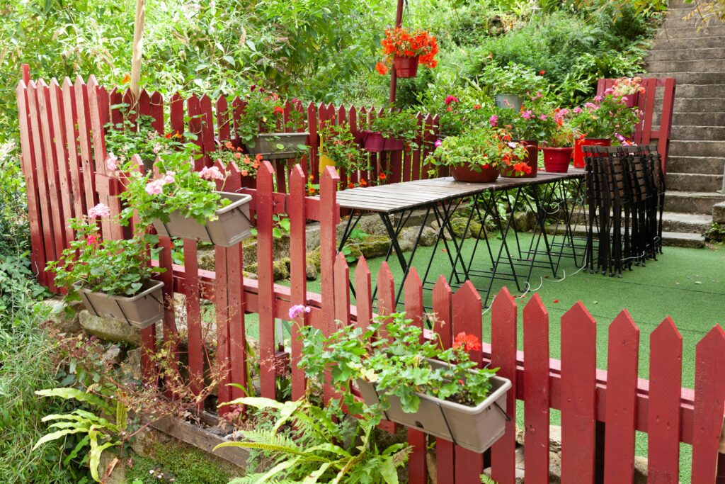 Artificial grass garden with fencing and plants