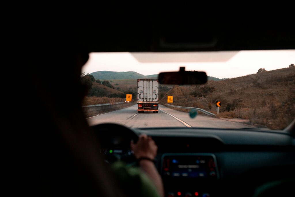 Person driving a vehicle with a truck in front of them