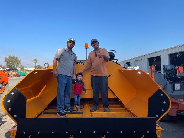 Men and a child on machinery