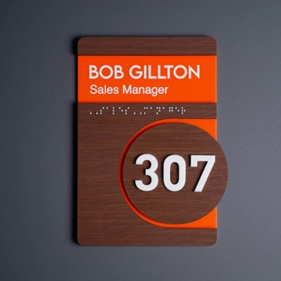 Orange and brown numbered door sign