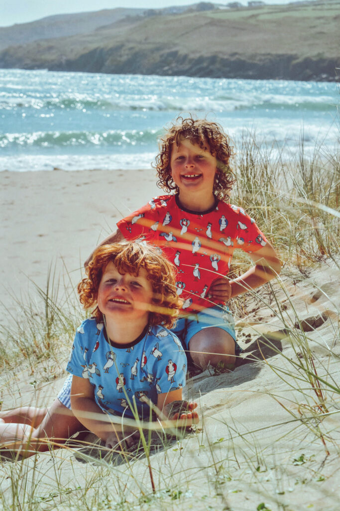 Two boys on a white sand beach