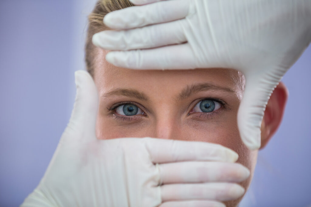 Doctor examining female patient's eyes