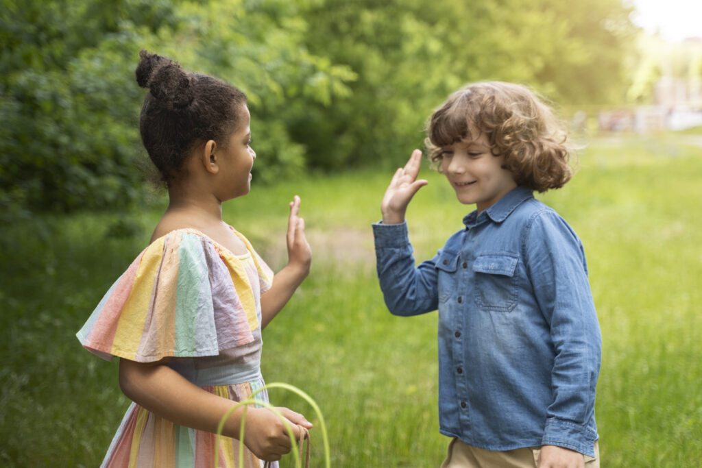 Children high fiving each other