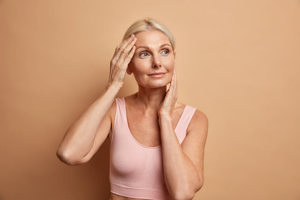 Older woman in a pink top with glowing skin