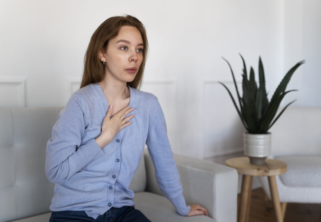 Woman with her hand to her chest
