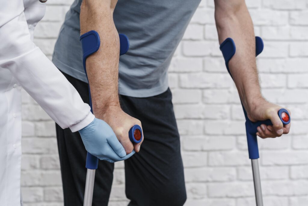 Person on crutches with a doctor