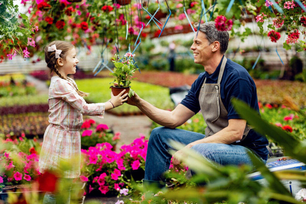Father giving his daughter a potted flower