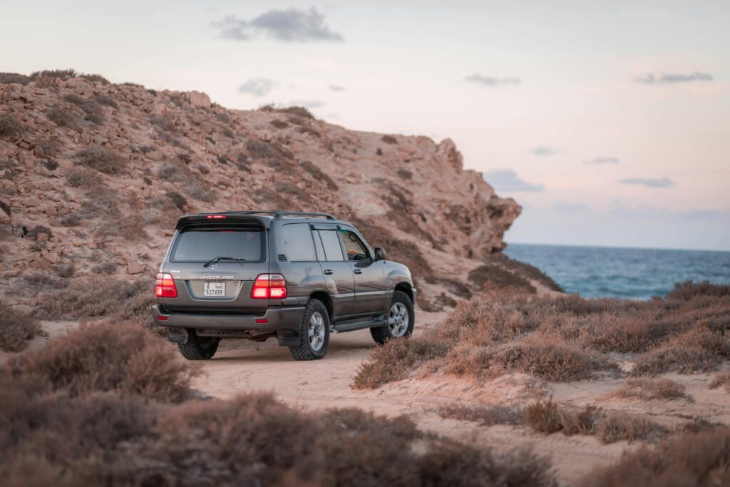 Toyota Land Cruiser on rocky terrain looking out to sea