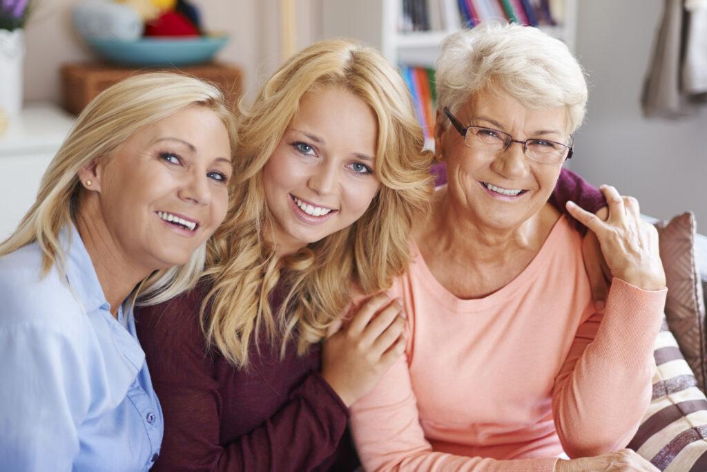 Multi-generational women smiling and embracing each other