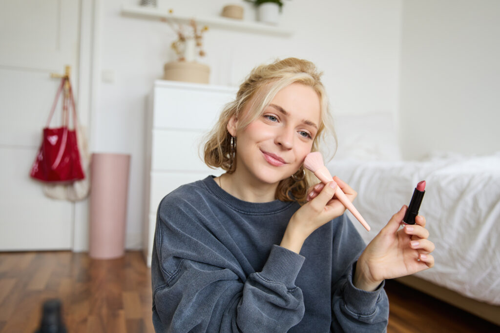 Pretty woman applying makeup