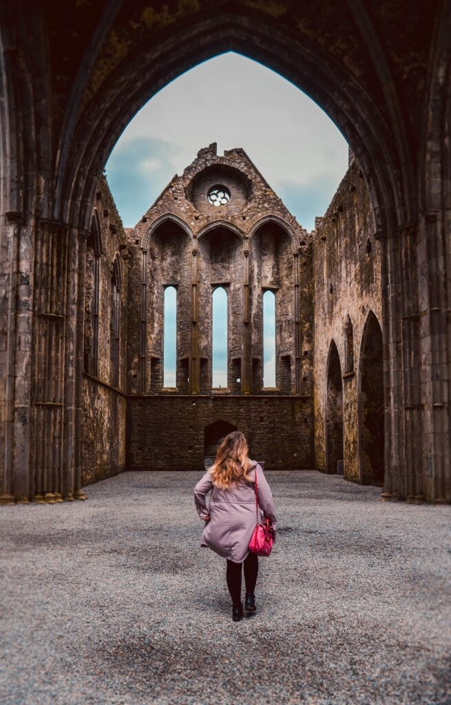 Woman wearing Pink standing inside the Rock of Cashel