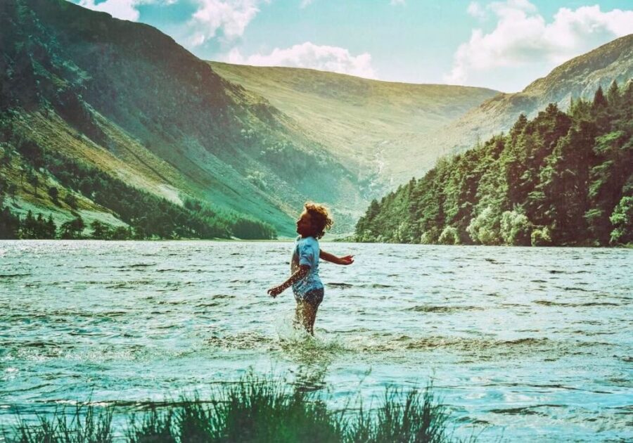 Child playing in the water at Glendalough