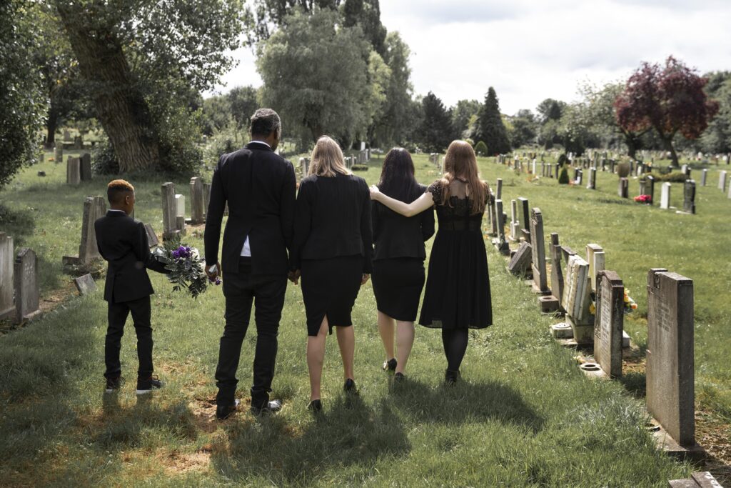 Family visiting grave of a loved one