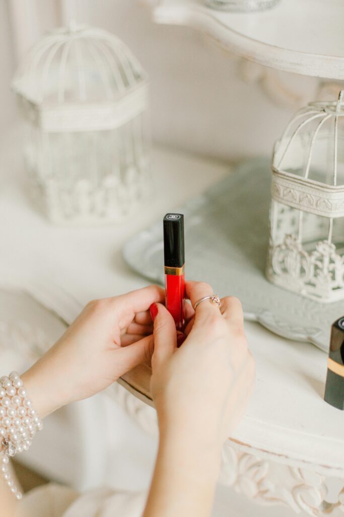 Anon woman holding a red lipgloss