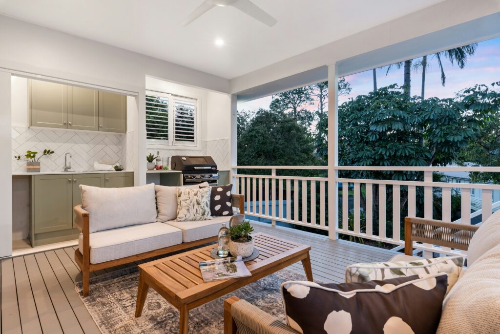 Outdoor decking space with couches, bar and kitchenette
