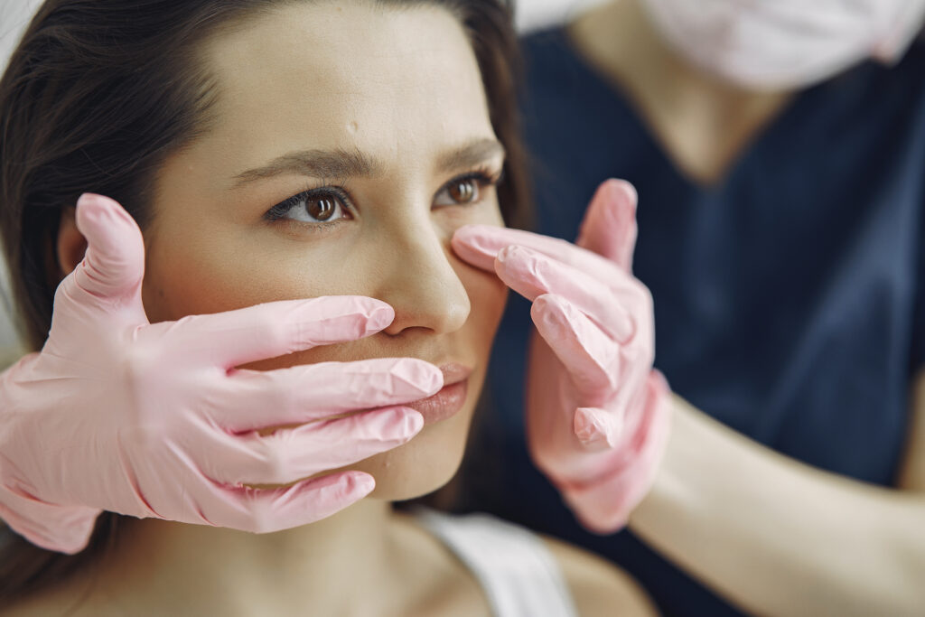 Woman getting a rhinoplasty consultation