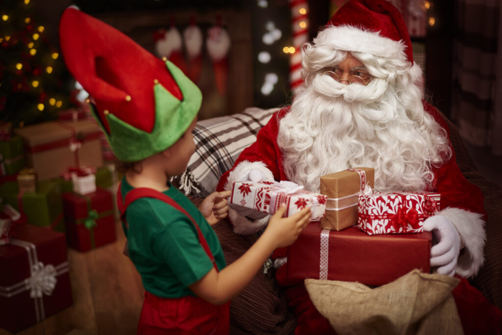 Santa with a boy dressed as an elf