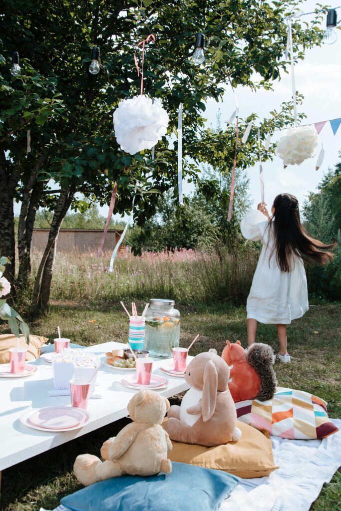 Girl in a white dress having a teddy bear's picnic